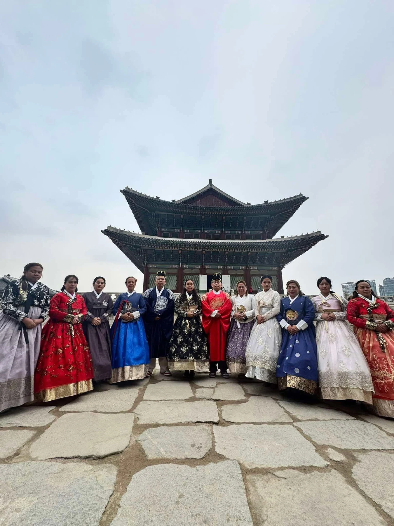 Travelers enjoying a cultural experience in traditional Korean dress
